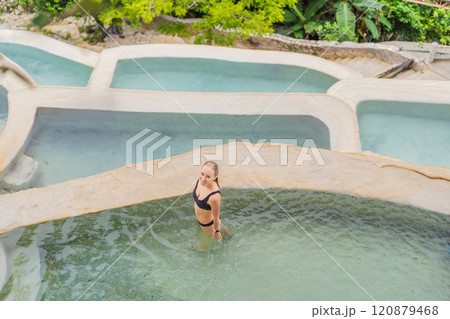 Female tourist at the hot springs of Grutas Tolantongo, Mexico. Adventure, relaxation, and natural wellness concept Female tourist at the hot springs of Grutas Tolantongo, Mexico. Adventure, relaxation, and natural wellness concept 120879468