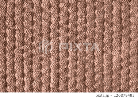 Demonstrating the colors of 2025 - Mocha Mousse. Knitted brown background. Large knitted fabric with a pattern. Close-up of a knitted blanket. Color concept. Demonstrating the colors of 2025 - Mocha Mousse. Knitted brown background. Large knitted fabric with a pattern. Close-up of a knitted blanket. Color concept. 120879493
