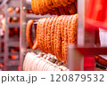 Smoked sausages hanging in a meat factory processing plant 120879532