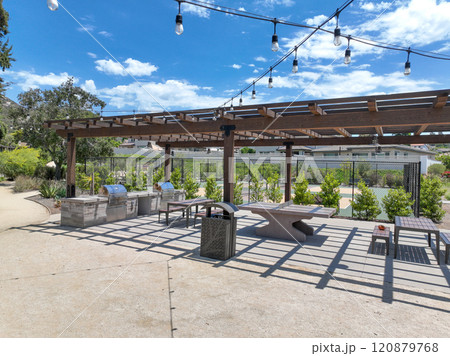 Covered gathering area in city park with green wood picnic tables Covered gathering area in city park with green wood picnic tables 120879768