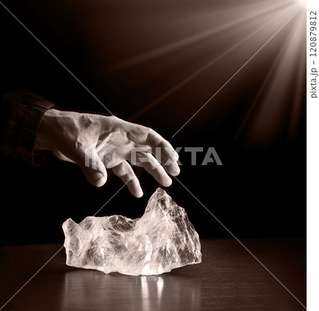 The hand reaches out to steal the precious stone The hand reaches out to steal the precious stone 120879812