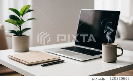 Minimalist workspace with laptop, notebook, and coffee cup 120880692