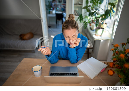 Dedicated woman organize lesson plans and learning with laptop and notepads. Adult student and exams Dedicated woman organize lesson plans and learning with laptop and notepads. Adult student and exams 120881809