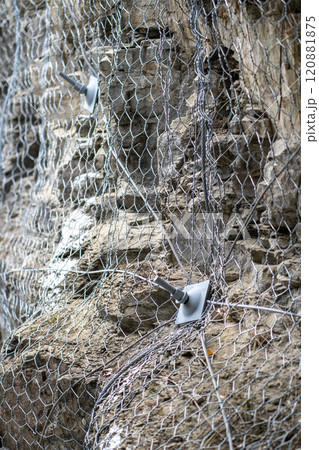Landslide and rock sliding prevention in Turkey, reinforcing mountain slope with metal mesh. Landslide and rock sliding prevention in Turkey, reinforcing mountain slope with metal mesh. 120881875