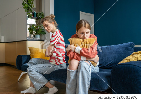 Upset frustrated mother and teenage daughter ignoring each other after quarrel at home, not talking 120881976