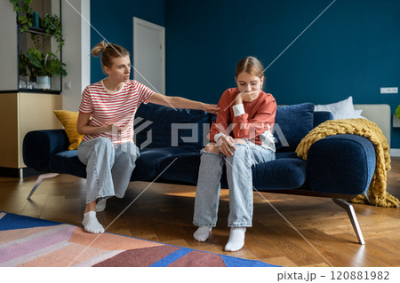 Young woman loving mother trying to speak with upset depressed teen daughter 120881982
