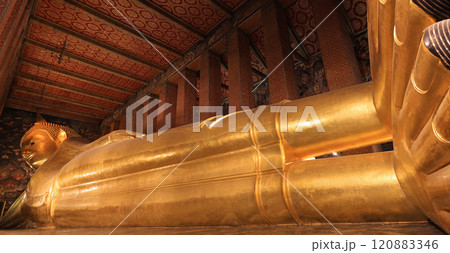 View of the large statue of the Reclining Buddha in Wat Pho (Temple of The Reclining Buddha) in Bangkok, Thailand View of the large statue of the Reclining Buddha in Wat Pho (Temple of The Reclining Buddha) in Bangkok, Thailand 120883346
