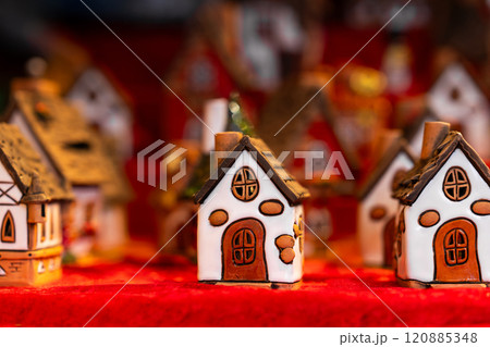 Ceramic Miniature Houses arranged on red display Ceramic Miniature Houses arranged on red display 120885348