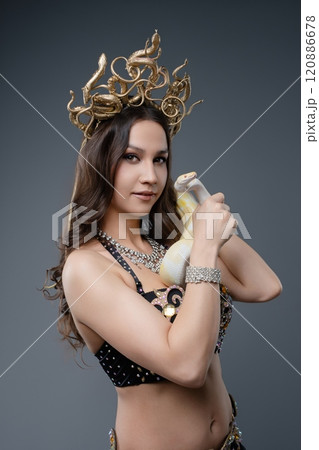 Elegant performer showcases traditional attire and unique milk bottle 120886678