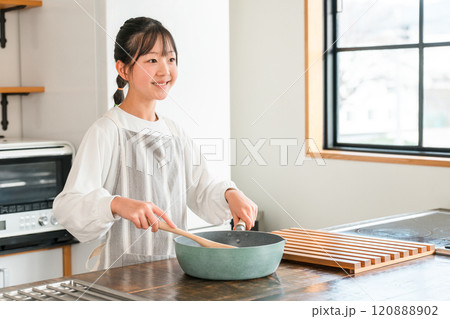 家のキッチンで料理を作る子供（小学生・中学生・高校生・女の子） 120888902