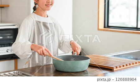 家のキッチンで料理を作る子供（小学生・中学生・高校生・女の子） 120888904