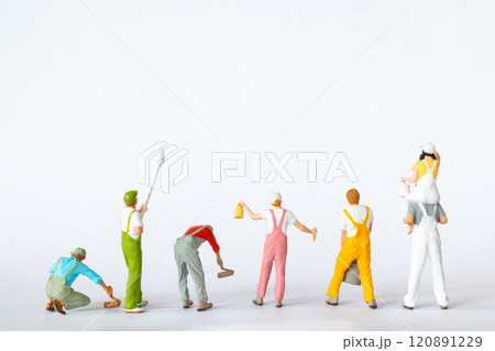 Miniature figures dressed as painters in overalls on a clean white background Miniature figures dressed as painters in overalls on a clean white background 120891229