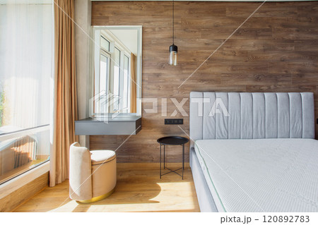 large modern bedroom bed with headboard warm wooden laminate on wall 120892783