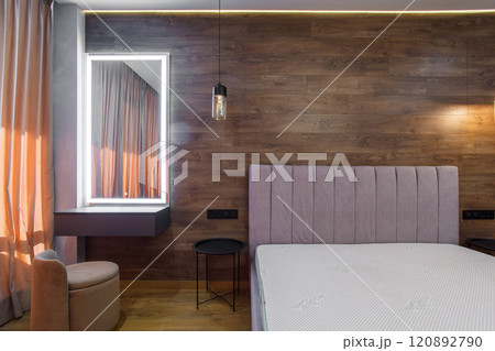 large modern bedroom bed with headboard warm wooden laminate on wall 120892790