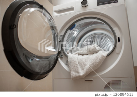 Inside of tumble dryer with clean white towels - new generation of dryer, household concept 120894513