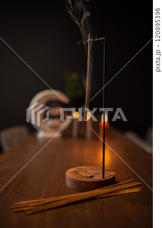 Incense sticks smoldering on table indoors, space for text 120895396