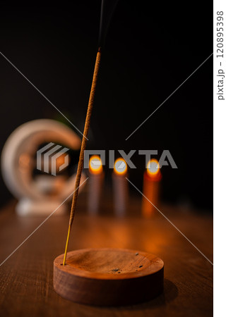 Incense sticks smoldering on table indoors, space for text Incense sticks smoldering on table indoors, space for text 120895398