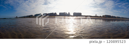 Panoramic View of Sandy Beach With Urban Skyline and Sunny Sky 120895523