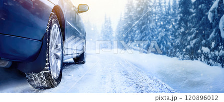 Car tires on winter road covered with snow close-up Car tires on winter road covered with snow close-up 120896012