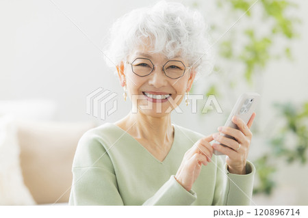 リビングで電話するシニア女性 リビングで電話するシニア女性 120896714