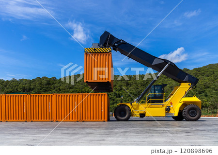 Reach stacker cargo forklift container box import export logistic transportation industrial, Reach stacker pick up container, Reach stacker container loader crane lifting maritime cargo container. 120898696