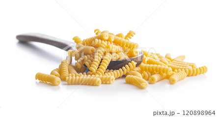 Uncooked italian pasta. Fusilli pasta on spoon isolated on white background. Uncooked italian pasta. Fusilli pasta on spoon isolated on white background. 120898964