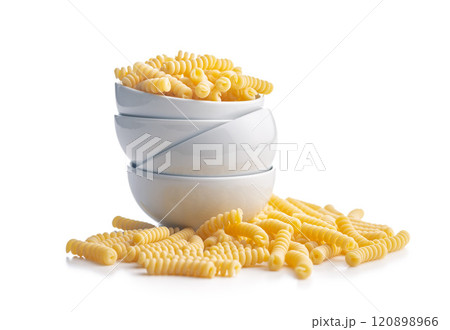 Uncooked italian pasta. Fusilli pasta in bowl isolated on white background. 120898966
