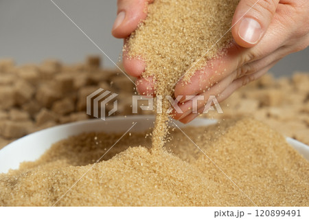 Hands pour crystalline cane brown unrefined healthy demerara sugar 120899491