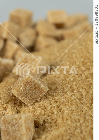 Brown cane unrefined demerara sugar in the form of crystals and cubes Brown cane unrefined demerara sugar in the form of crystals and cubes 120899501