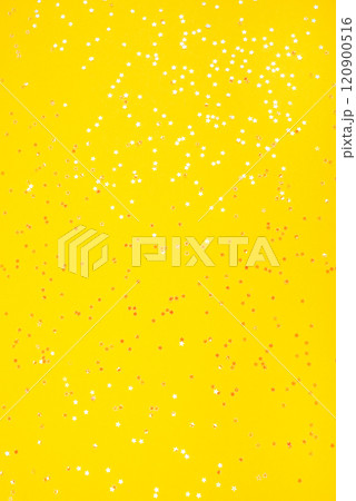 Tiny pearl stars on yellow background. 120900516