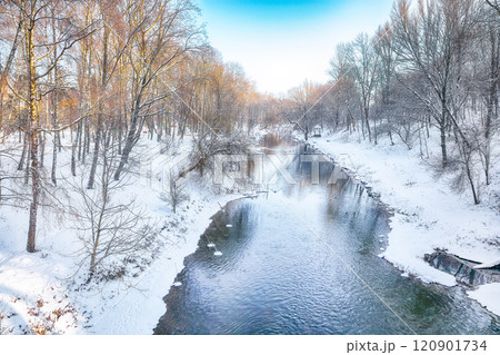 Breathtaking landscape in city park with snowy trees and beautiful reflection in frozen river. Breathtaking landscape in city park with snowy trees and beautiful reflection in frozen river. 120901734