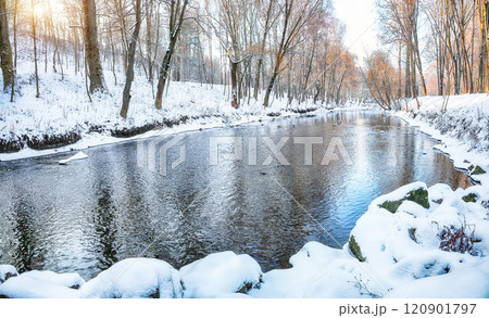 Outstanding landscape in city park with snowy trees and beautiful reflection in frozen river. Outstanding landscape in city park with snowy trees and beautiful reflection in frozen river. 120901797