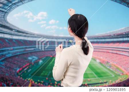 スタジアムで応援をする若い女性 120901895