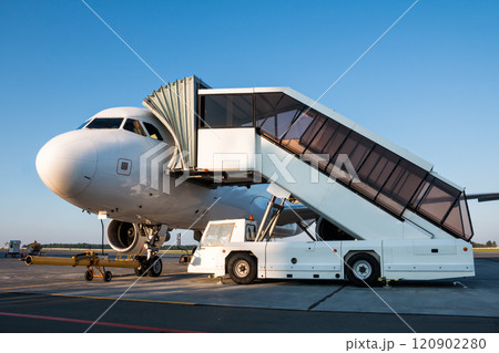 Passenger jet plane with boarding steps vehicle at the airport apron prepare for the departure 120902280
