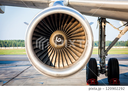 Close-up of engine and main landing gear of passenger aircraft 120902292