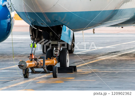 Towbar attached to the front landing gear of the airplane Towbar attached to the front landing gear of the airplane 120902362