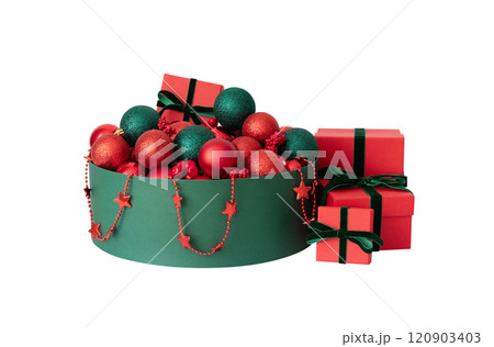 A green box with red Christmas decorations and gift boxes isolated on white background. New Year decor. 120903403