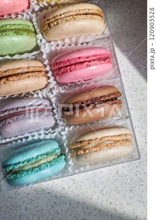 Bright colorful cakes French Macarons with white paperpan in plastic box 120903528