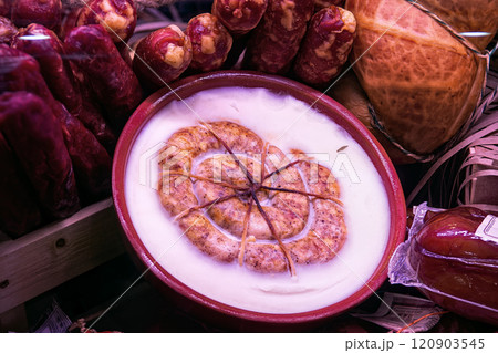 Traditional homemade ring sausage in solidified pork fat in gift ceramic bowl top view. Traditional sausages are sale in butcher shop. 120903545