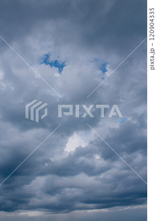gloomy dark clouds with blue gaps of clear sky gloomy dark clouds with blue gaps of clear sky 120904335