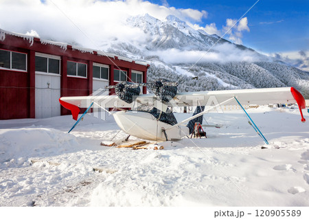 White rescue hydroplane on ski landing gear in the winter mountains White rescue hydroplane on ski landing gear in the winter mountains 120905589