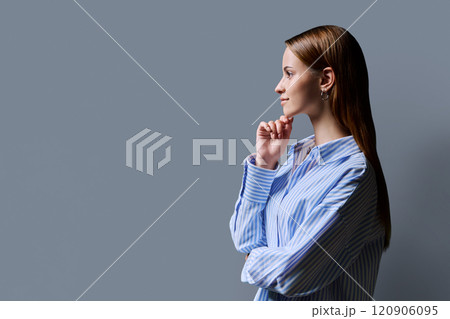 Profile portrait of young teenage girl, gray studio copy space background Profile portrait of young teenage girl, gray studio copy space background 120906095
