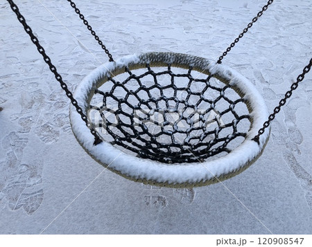 swing in winter, round seat covered with snow swing in winter, round seat covered with snow 120908547