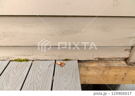 Wood Siding on House shows peeling and cracked painting and early signs of decay and rot Wood Siding on House shows peeling and cracked painting and early signs of decay and rot 120908817