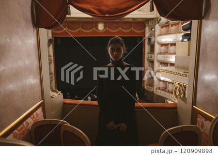 An Elegant Performer Gracefully Takes Center Stage Within a Beautiful Theatre Box Setting 120909898