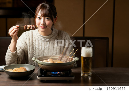 おでんの牛スジ肉を食べる女性 120911633