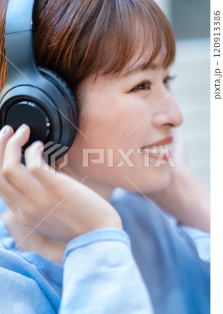 ヘッドホンで音楽を聴くショートボブの若い女性 ヘッドホンで音楽を聴くショートボブの若い女性 120913386