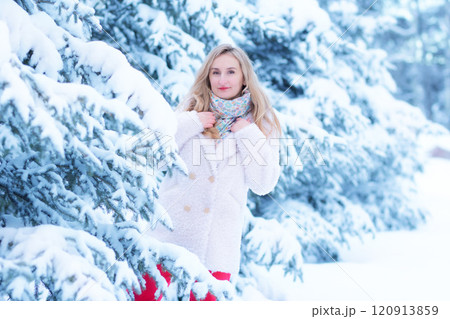Beautiful woman among white snowy trees in the forest. 120913859