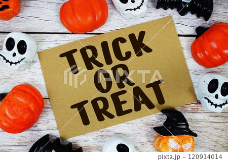 Trick or Treat text with Halloween Element on wooden background Trick or Treat text with Halloween Element on wooden background 120914014