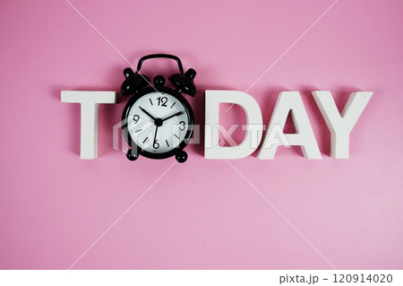 Today alphabet letters with alarm clock on pink background 120914020